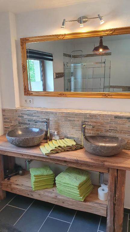 a bathroom with two sinks and a mirror at Chalet Weitsee in Reit im Winkl