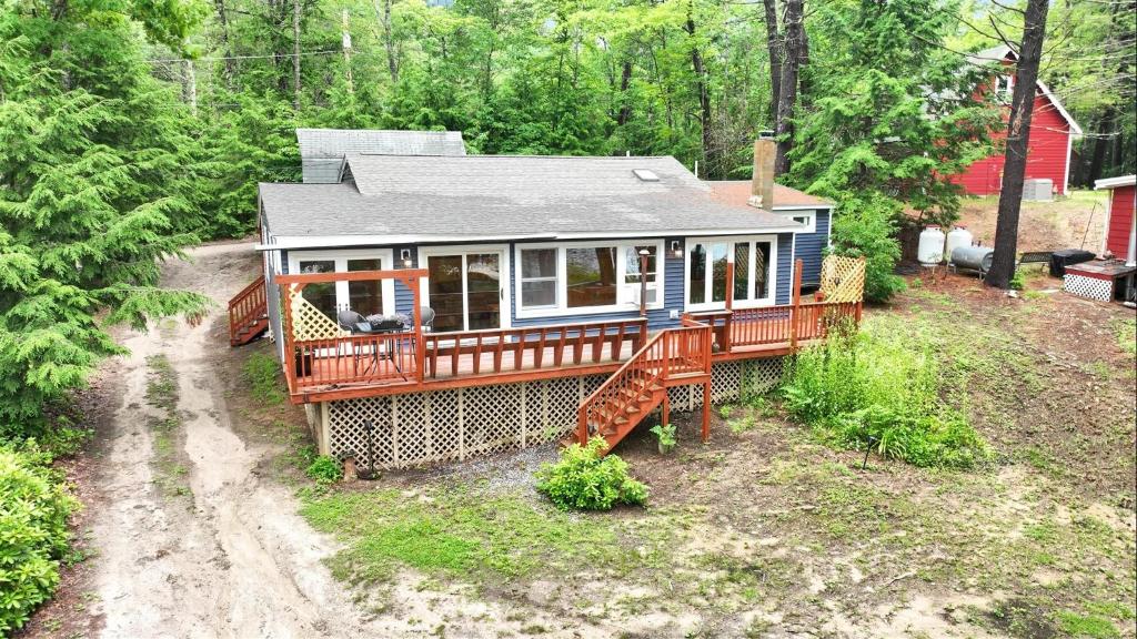 a large house in the middle of a forest at CRYSTAL OASIS- LIMIT 8 villa in North Sebago