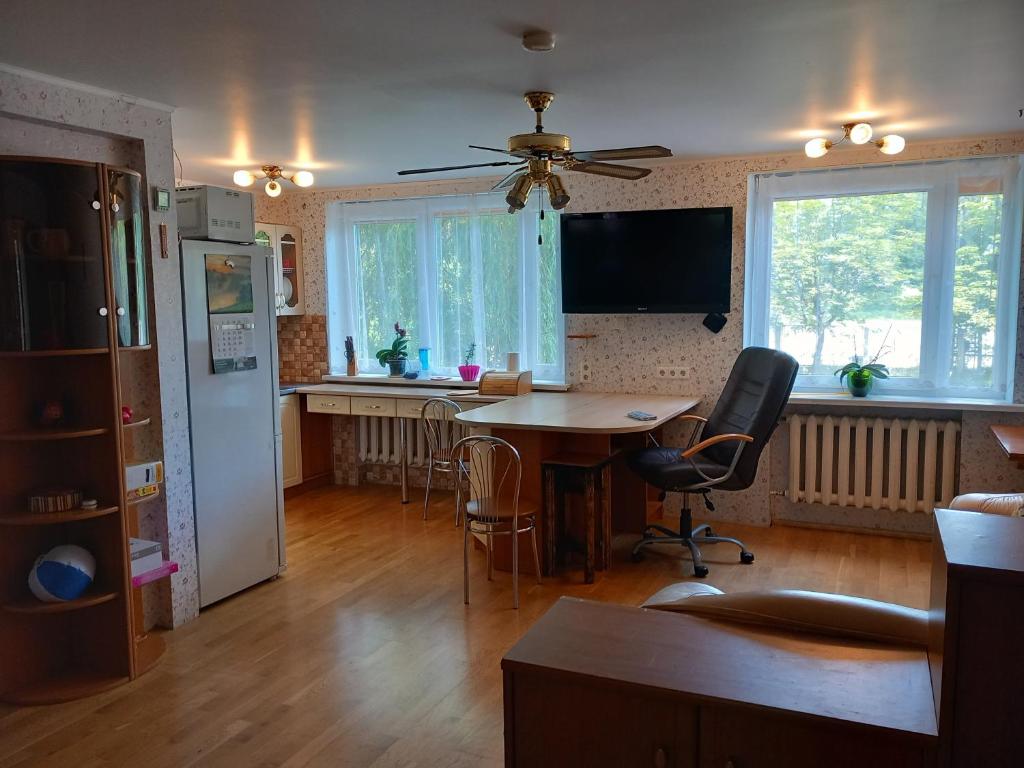 a kitchen with a table and a refrigerator at Dzintari in Jūrmala