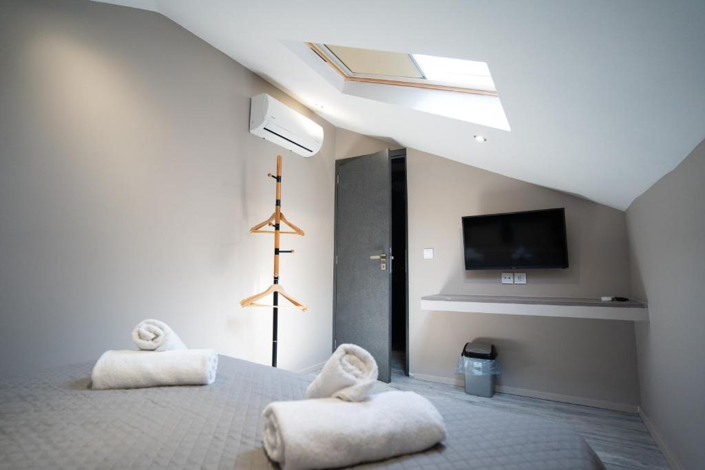 a bedroom with two white towels on a bed at Parthenis Riviera Hotel in Athens