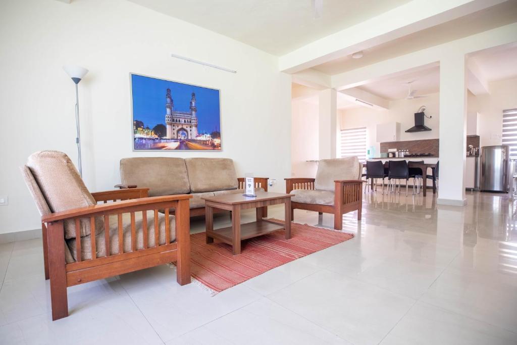 a living room with a couch and a table at Neemtree Apartments in Hyderabad