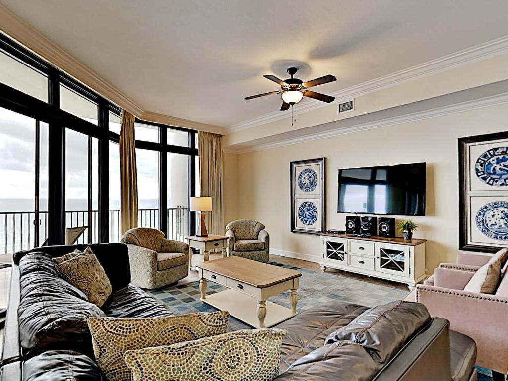 a living room with a couch and a flat screen tv at Phoenix West II #2109 in Orange Beach