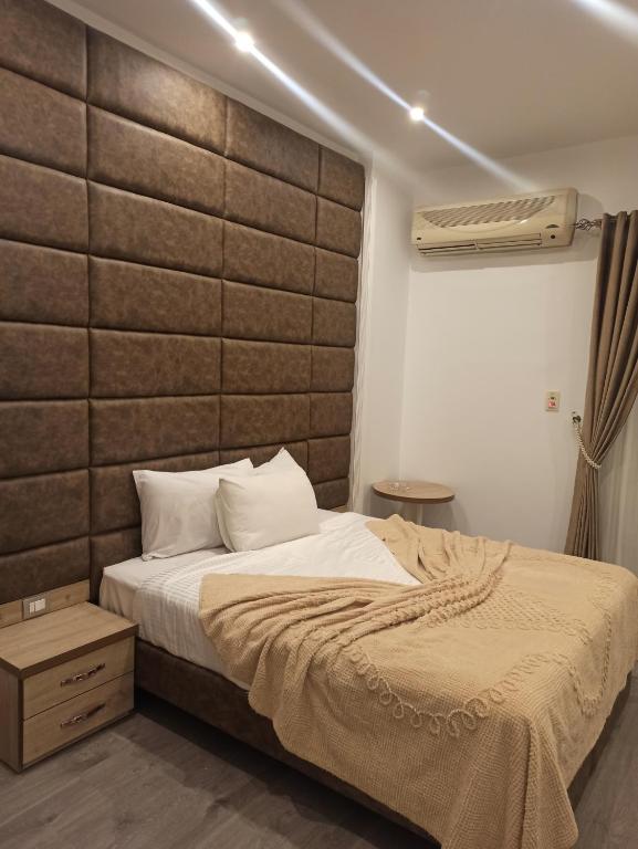 a bedroom with a bed with a large headboard at RED SEA HOTEL - فندق ريد سى in Suez