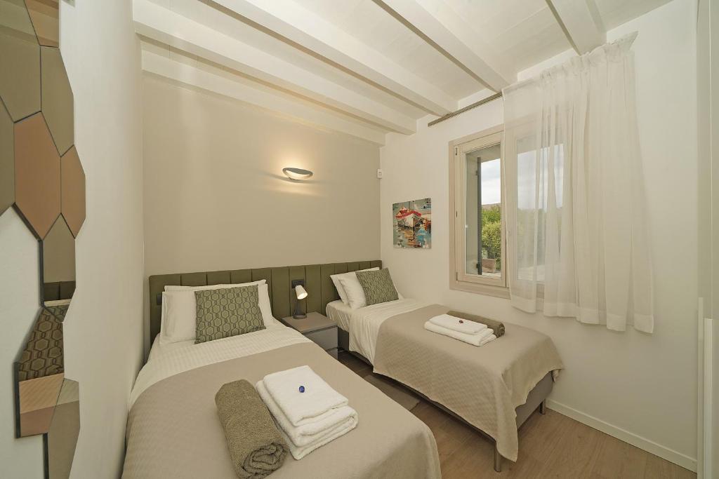 מיטה או מיטות בחדר ב-Alma Garda Home
