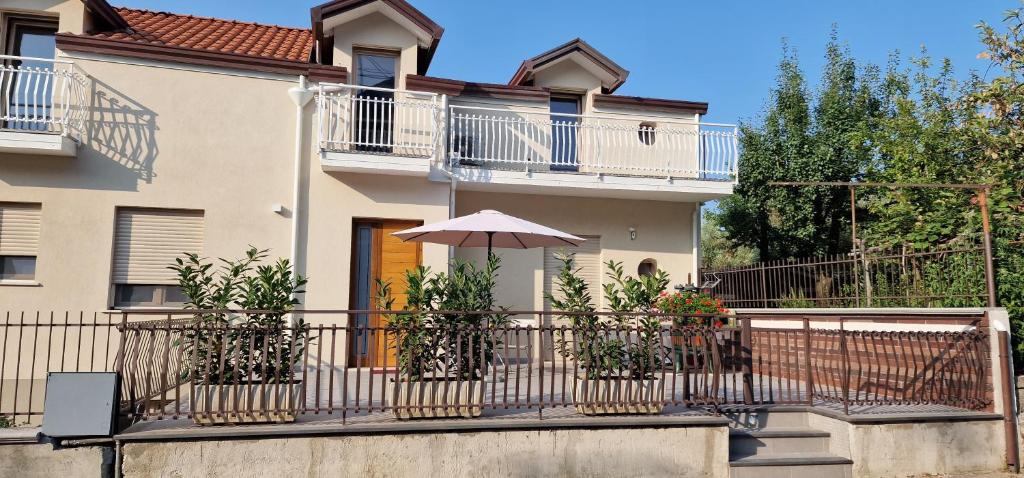 a house with a fence and an umbrella at Monti d'aMare in Agerola