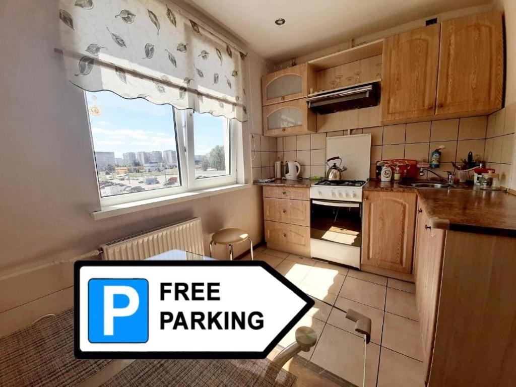 a small kitchen with a free parking sign on it at Sunny Apartment in Rīga