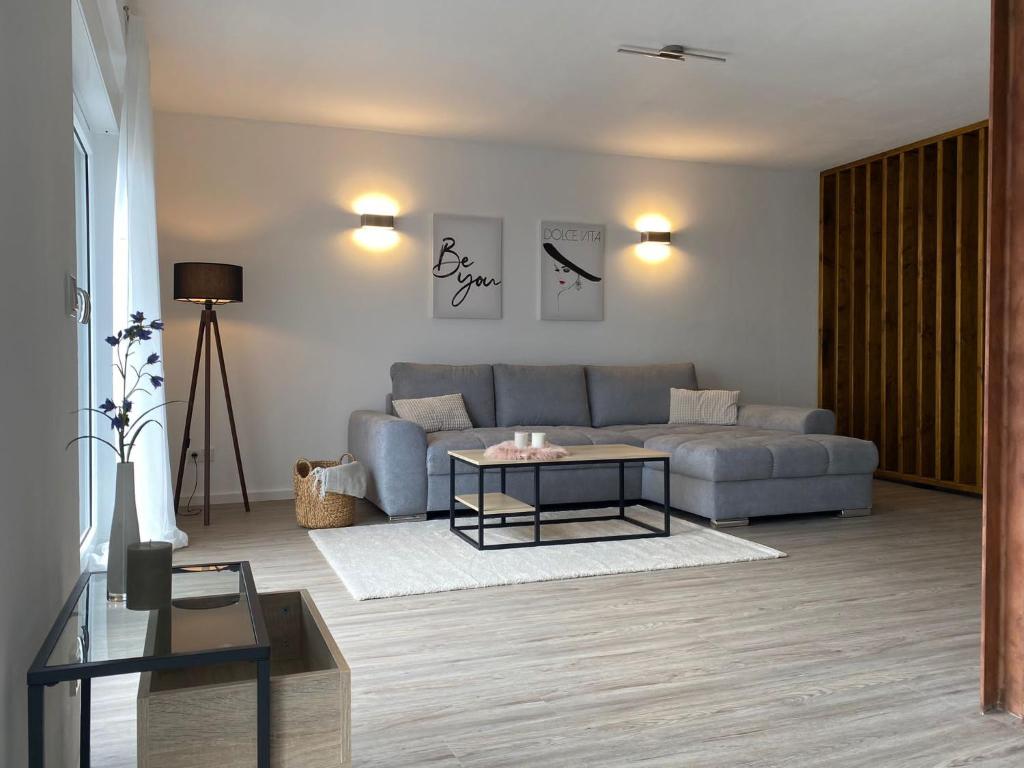 a living room with a couch and a table at Moselmoni in Bullay