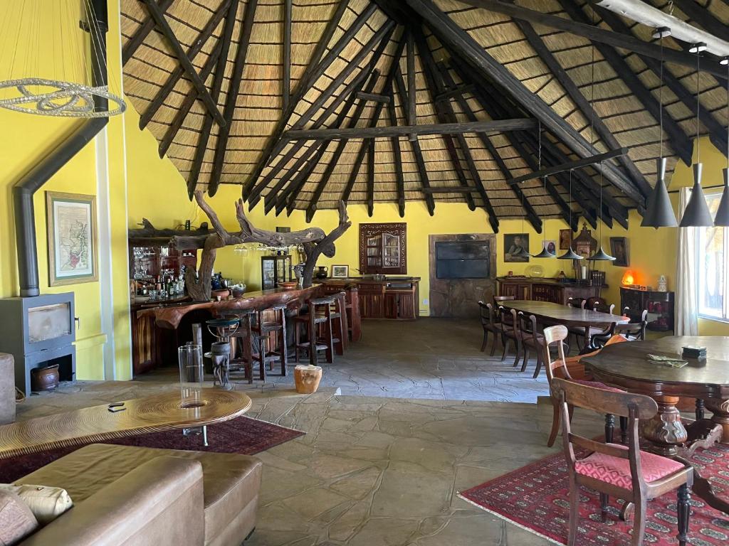 a large room with tables and chairs in a building at The Farm Shop in Groutfontein