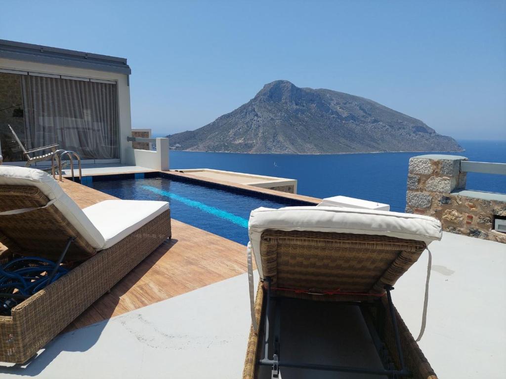 a swimming pool with a view of a mountain at Villa Kairos- Aegean Sea in Masouri