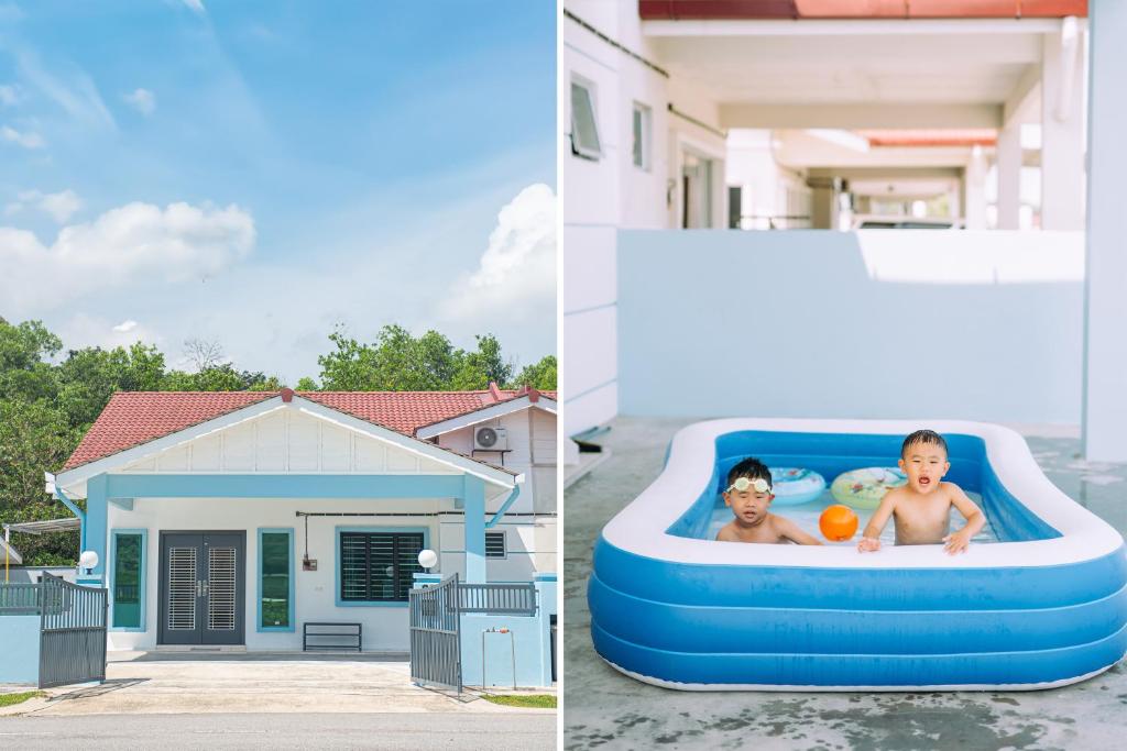 un hombre y un niño en una piscina inflable frente a una casa en No 19 Studio Homestay (Semi-D), Port Dickson (up to 13 pax) en Port Dickson