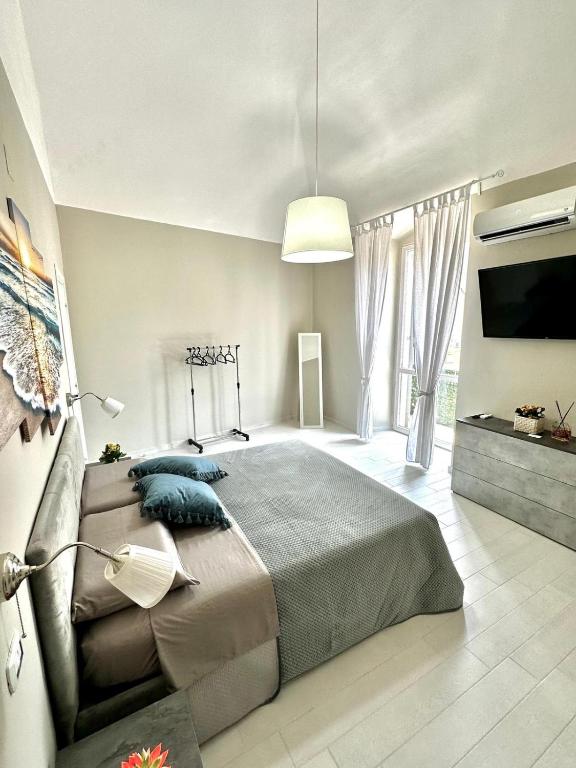 a bedroom with a large bed and a television at B&B La Reggia del Sol in Trani