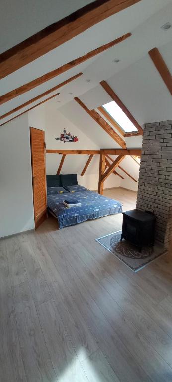 a room with a bed in a attic at Vėtrungėlė in Nida