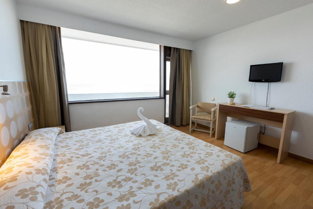 Postel nebo postele na pokoji v ubytování Hotel Flamero