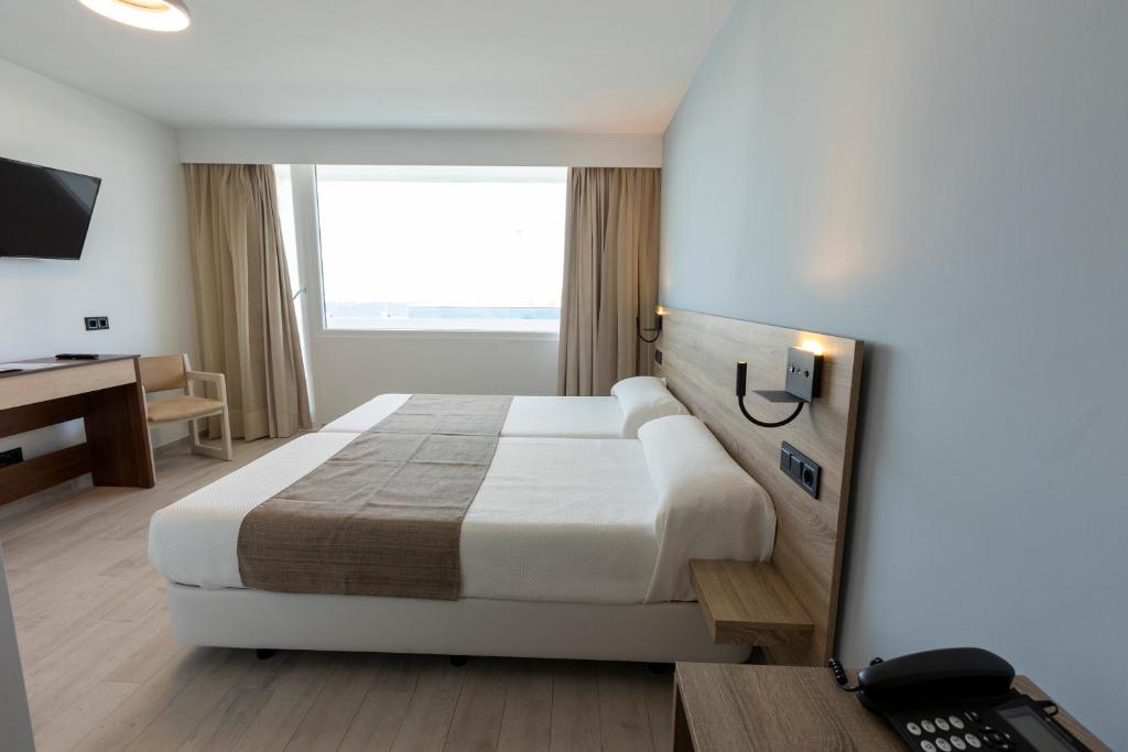 Postel nebo postele na pokoji v ubytování Hotel Flamero