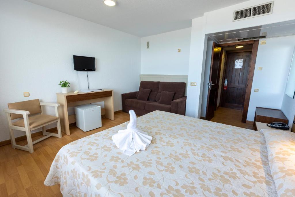 Postel nebo postele na pokoji v ubytování Hotel Flamero