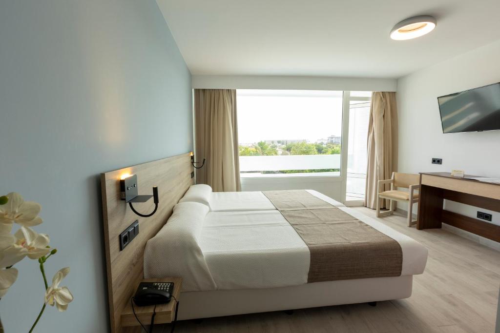 Postel nebo postele na pokoji v ubytování Hotel Flamero