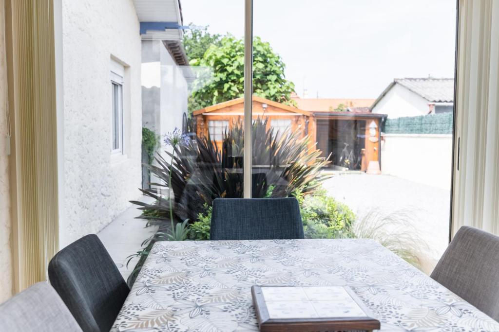 d'une table, de chaises et d'une fenêtre. dans l'établissement La Teste hypercentre !au calme proche prés-salés, à La Teste-de-Buch