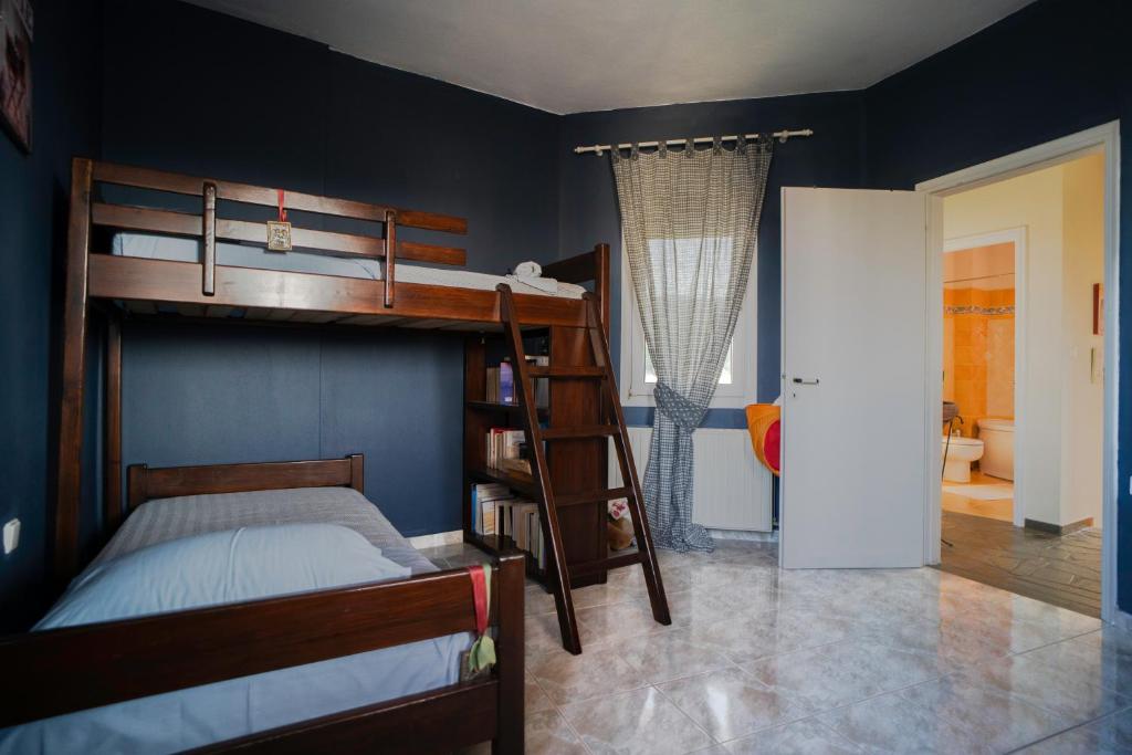 a bedroom with a bunk bed and a bathroom at Vacation House in Agiokampos in AgiaKampos