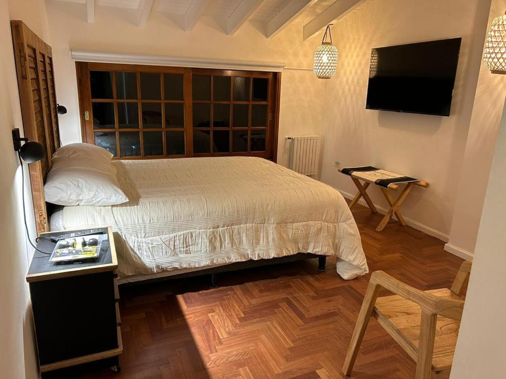 Postel nebo postele na pokoji v ubytování Oeste suites