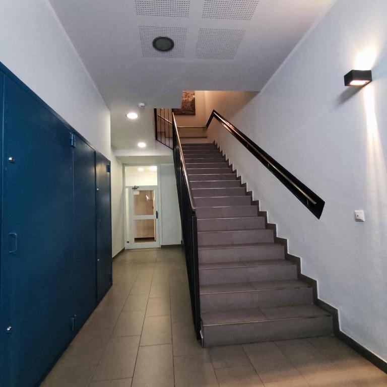a hallway with a staircase in a building at Aparthotel Meseguer in Alcañiz