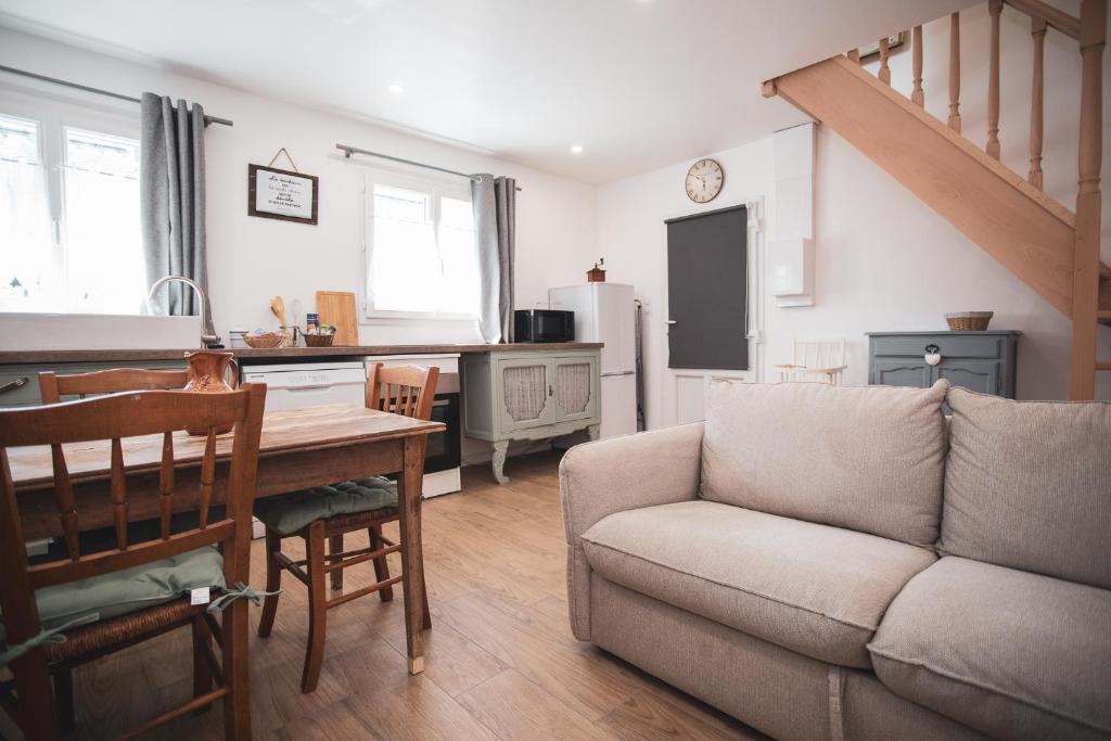 a living room with a couch and a table at La romance de Laura in Arrest