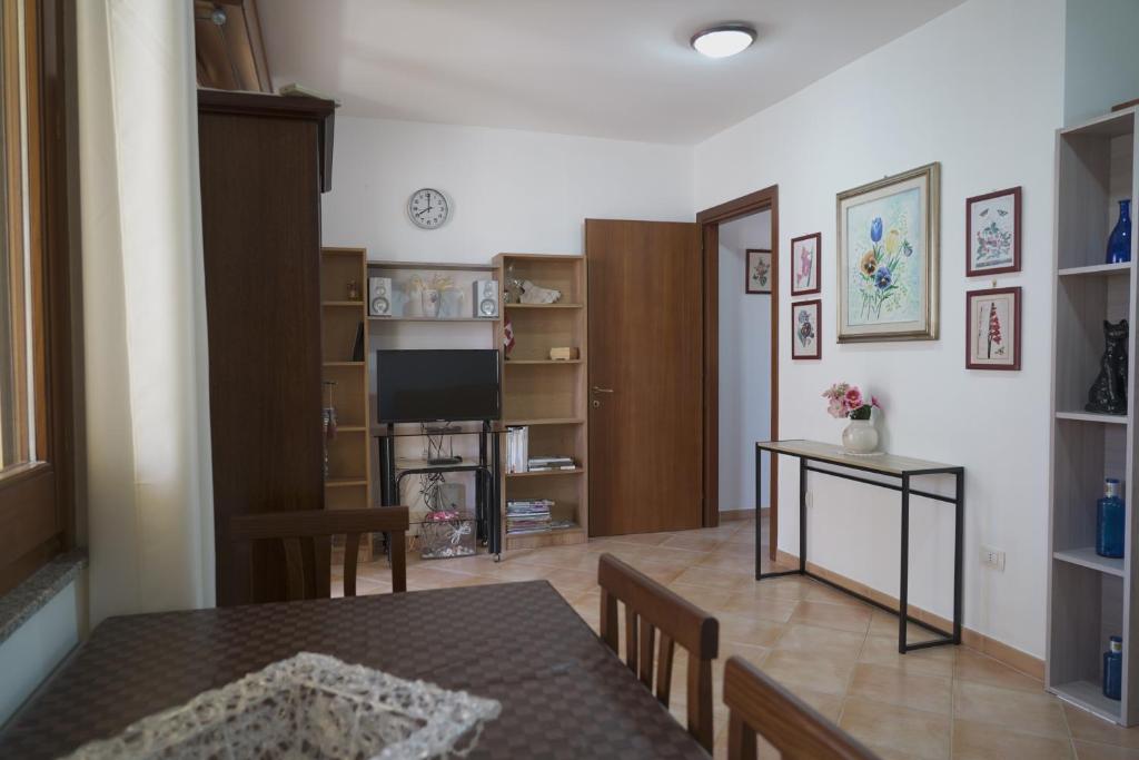 ein Wohnzimmer mit einem Tisch und einem Esszimmer in der Unterkunft Loft dei Mandorli in Su Forti