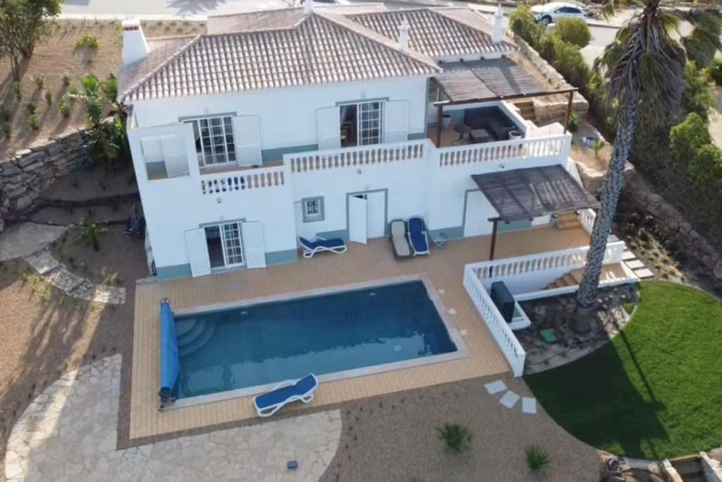 an aerial view of a house with a swimming pool at Stunning Villa with Pool & View near beach in Budens