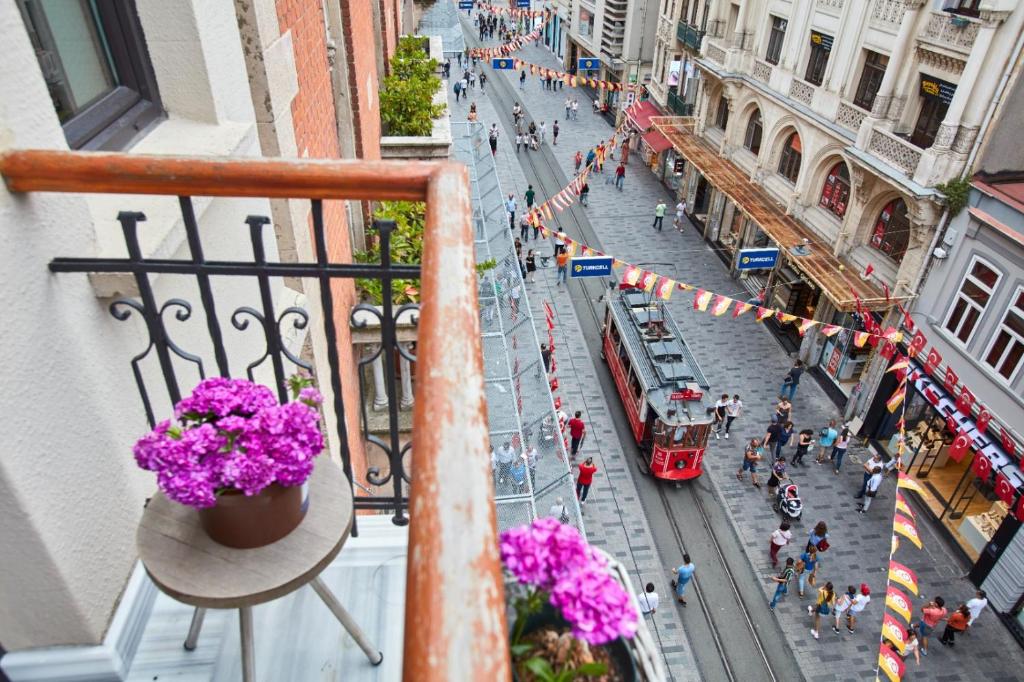 un balcón con flores y vistas a una calle de la ciudad en Magnova Studios, en Estambul