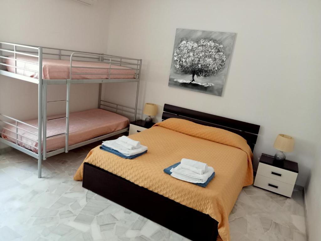 1 dormitorio con litera y toallas en Relax in valle, en Martina Franca