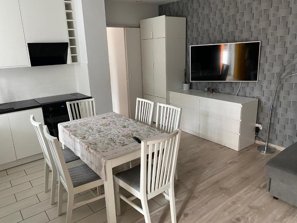 a kitchen with a table and chairs and a television at Mega widok 6 in Szklarska Poręba