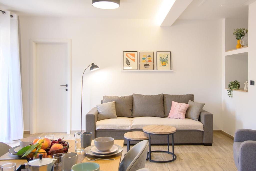 a living room with a couch and a table at Apartments & Rooms Darrer in Poreč
