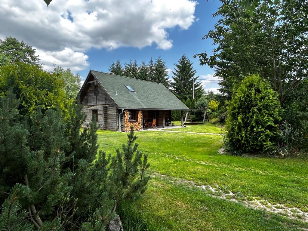 an old house in the middle of a field at log cabin in Czech-Saxon Switzerland in Šluknov