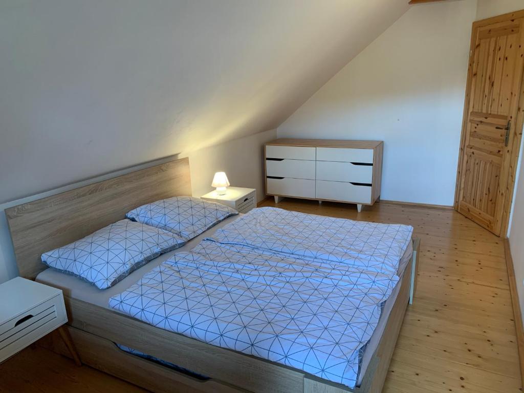 a bedroom with a bed and a dresser and a drawer at log cabin in Czech-Saxon Switzerland in Šluknov