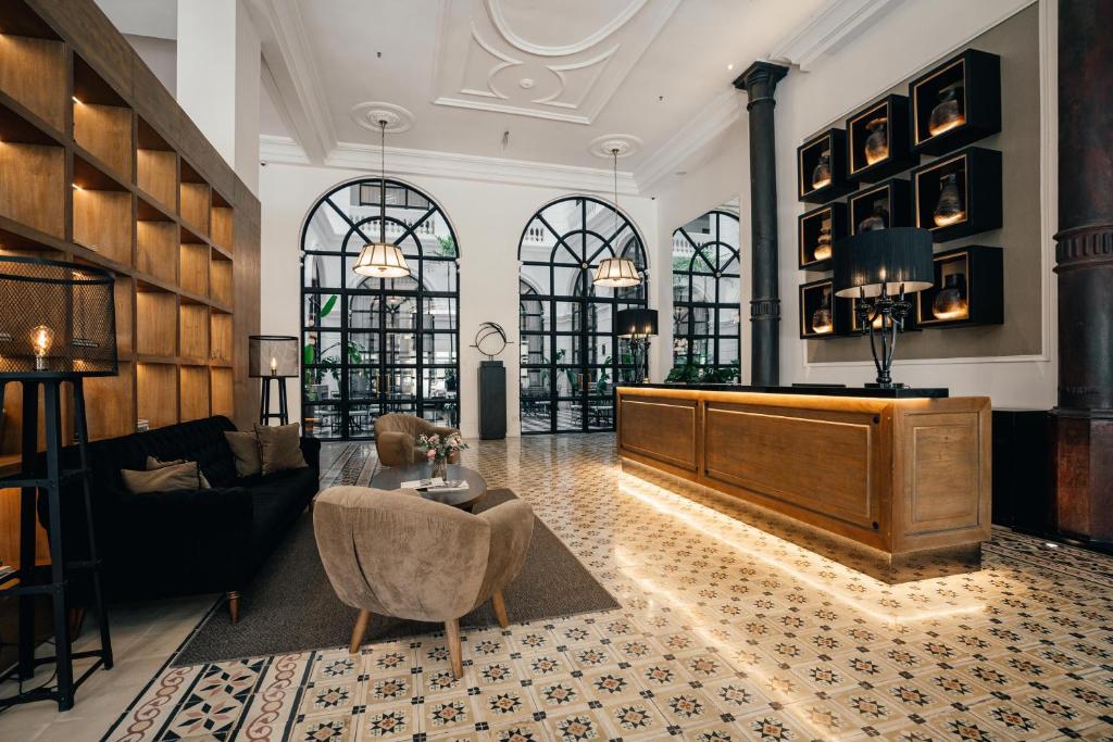 a large living room with a couch and a table at Palmaroga Hotel in Asunción