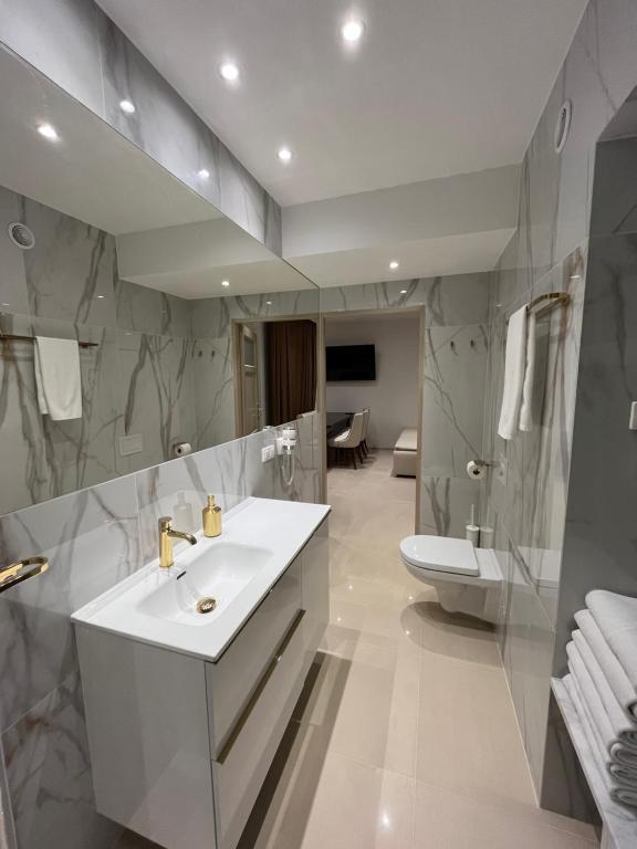 a bathroom with a sink and a toilet at Villa la Val, Apartamenty Wałbrzych in Wałbrzych
