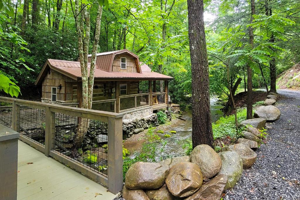 a log cabin in the middle of a forest at Down the Creek in Gatlinburg