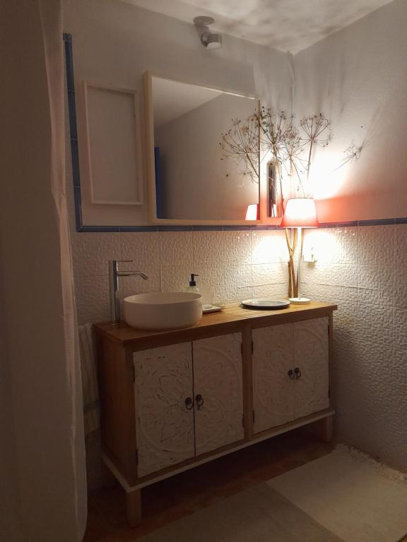 uma casa de banho com um lavatório e um espelho em Olive -Casa da Boavista em Alegrete