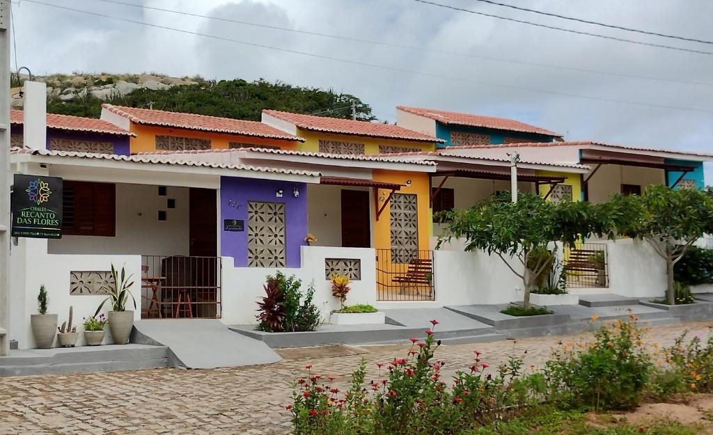 a house with colorful paint on it at Chalés Recanto das Flores RN in Monte das Gameleiras