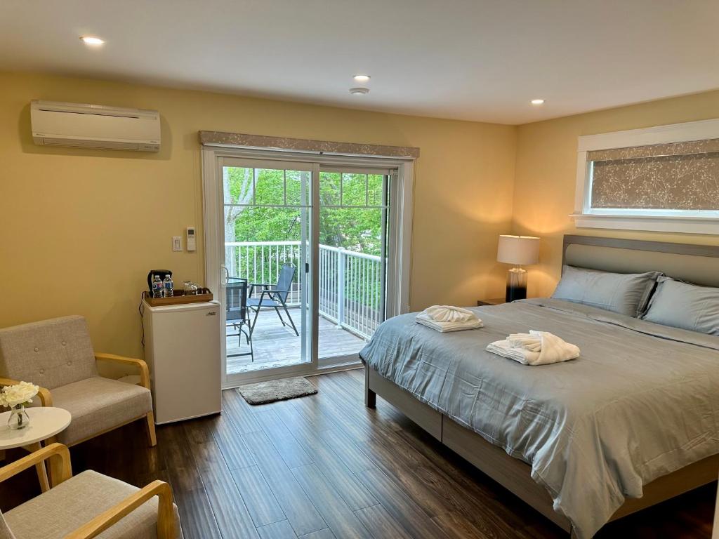 a bedroom with a bed and a balcony at Lotus Moon in Charlottetown