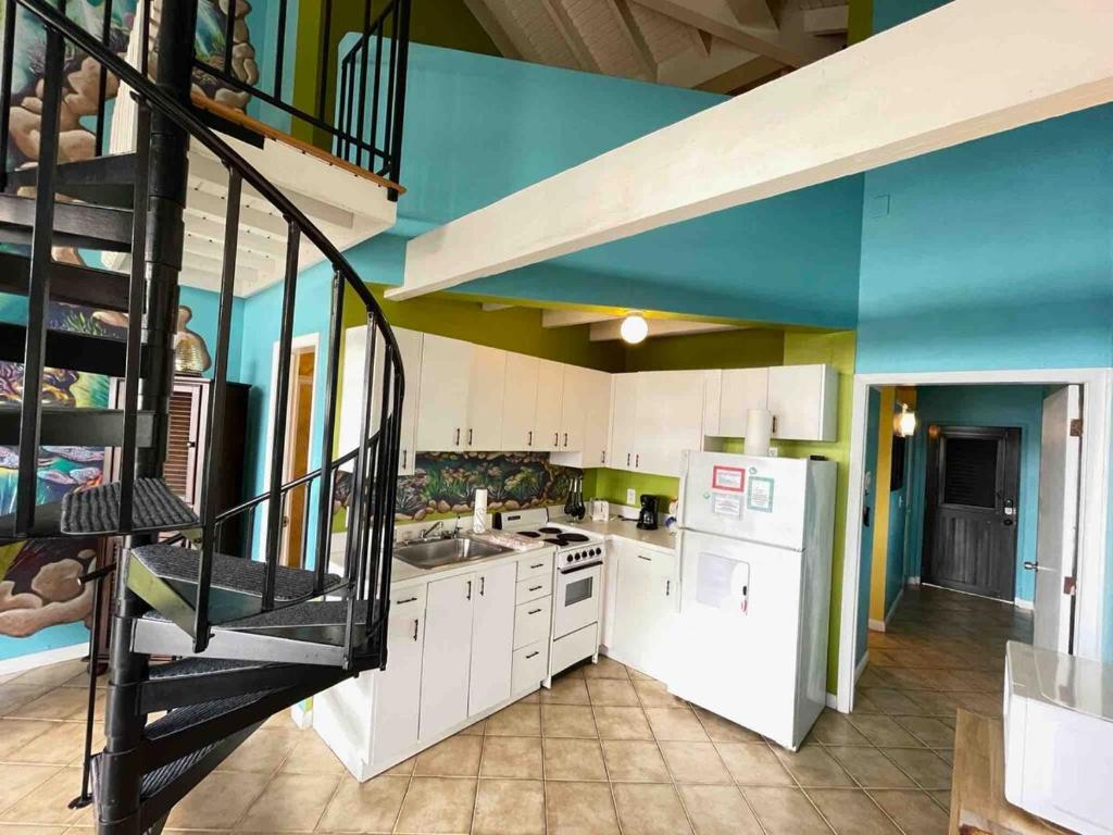 a kitchen with a spiral staircase in a house at Harbor View 2bed 1bath Loft In Downtown Red Hook! in East End