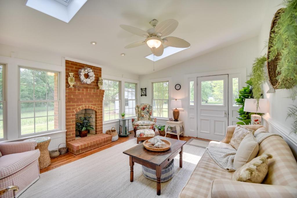 a living room with a couch and a fireplace at Mobjack Bay Rental on Private Cove! in Onemo