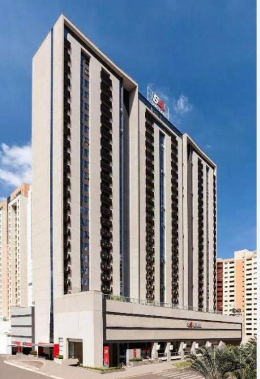 a large white building with many balconies on it at Flat Hotel S4 - Aguas Claras in Brasília