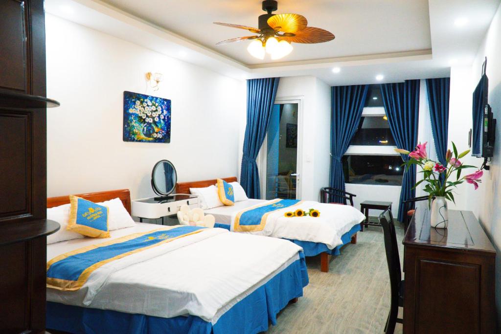 Cette chambre comprend 2 lits et une fenêtre. dans l'établissement Huong Mai Hotel, à Đà Lạt