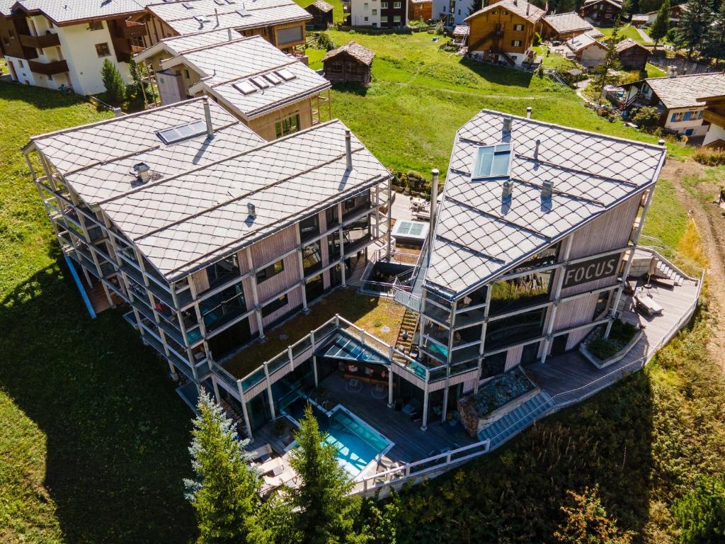 an aerial view of a house with a swimming pool at Matterhorn FOCUS Design Hotel in Zermatt