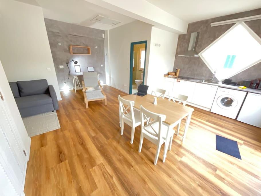 a living room with a table and chairs and a couch at Apartamento Mouzinho in Horta