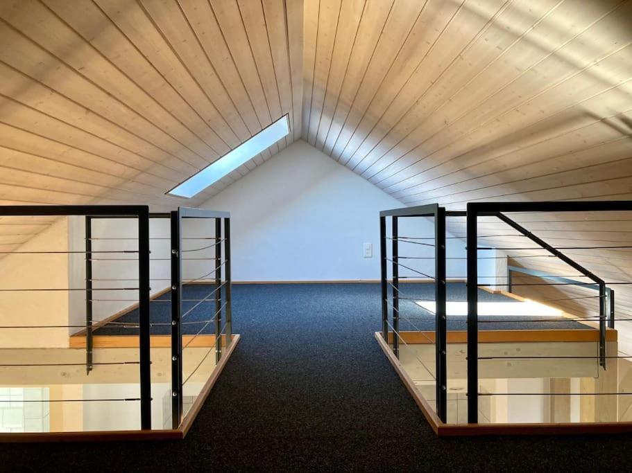 two bunk beds in a large room with a skylight at The St.Gallen Feel in St. Gallen