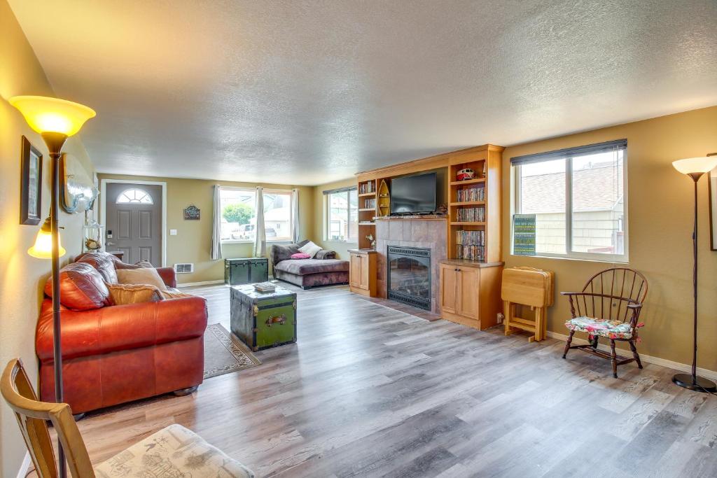 a living room with a couch and a fireplace at Winchester Bay Vacation Rental Near Dunes and ATV! in Reedsport