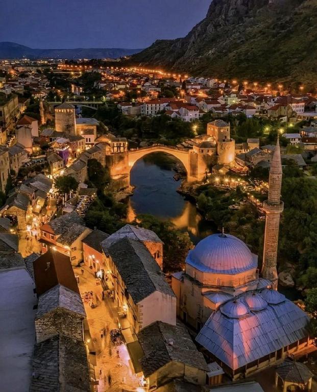 an aerial view of a city at night with a mosque at Studio Apartments Rio Verde in Mostar