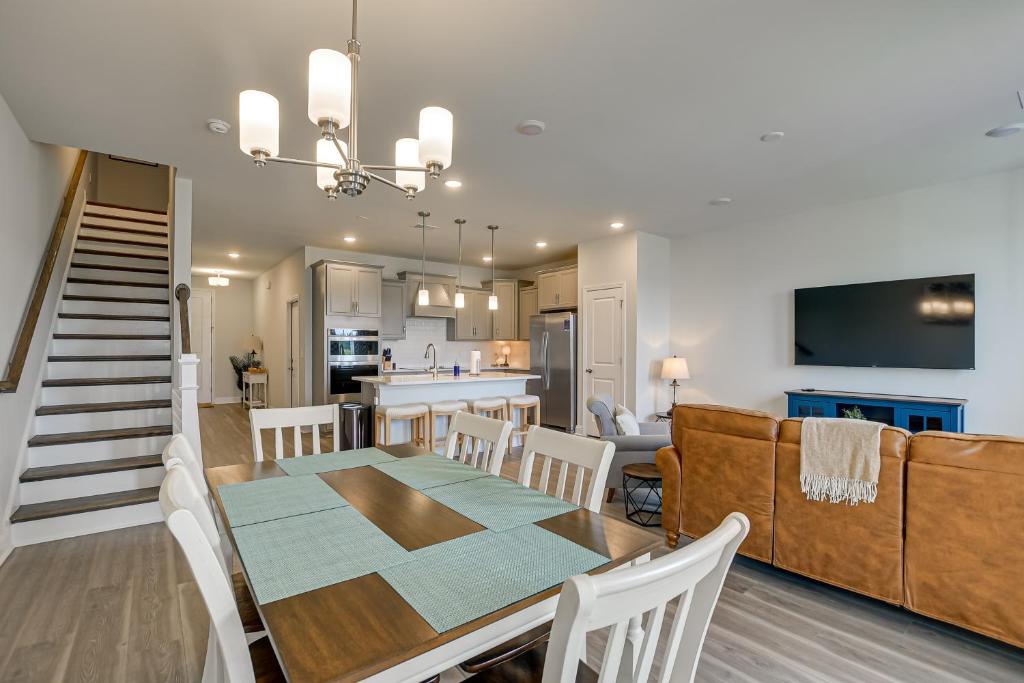 a dining room and kitchen with a table and chairs at North Myrtle Beach Townhome with Pool and Golf Access in Myrtle Beach