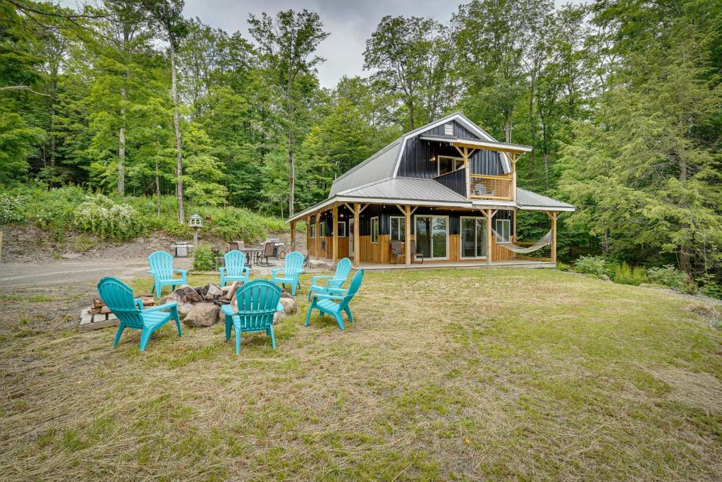 a group of chairs sitting in front of a cabin at Secluded Marathon Hideaway with Fire Pit and Views! in Marathon